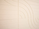 Beige tiles with circular patterns on a wall