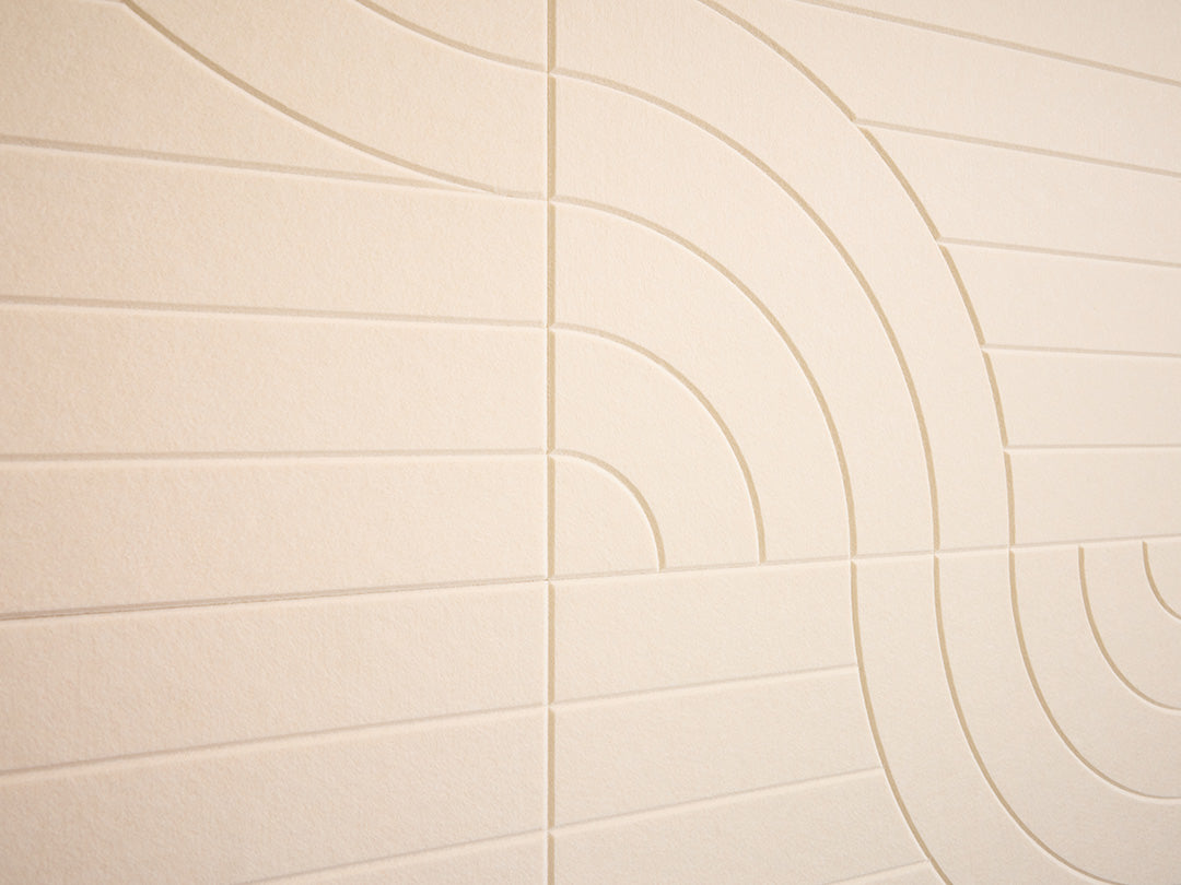 Beige tiles with circular patterns on a wall