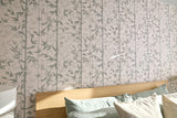 Bedroom with wooden headboard and bamboo-patterned wallpaper