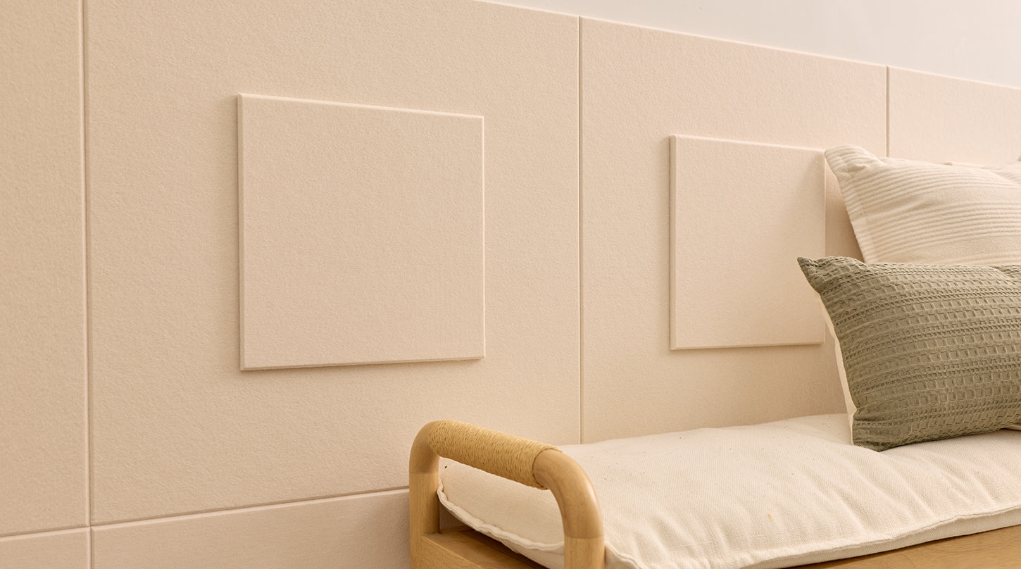 Wainscoting in a nook with a plant and a bench.