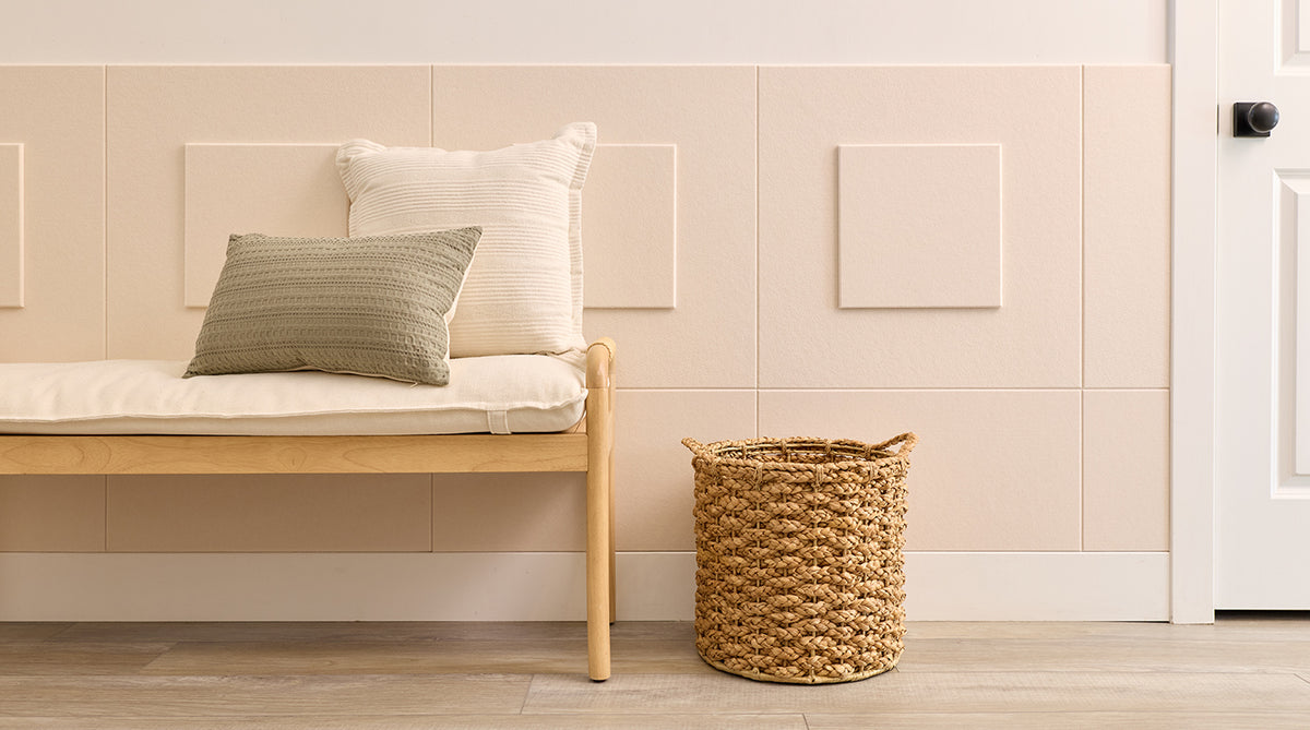 Wainscoting in a nook with a plant and bench.