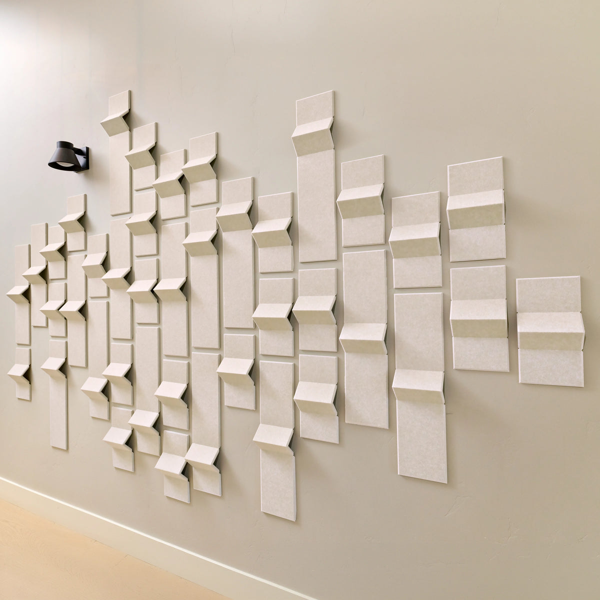 Cream felt tiles with acoustic benefits forming 3D points of dimension