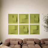 Light green acoustic felt tiles with points of design on a white wall above a couch