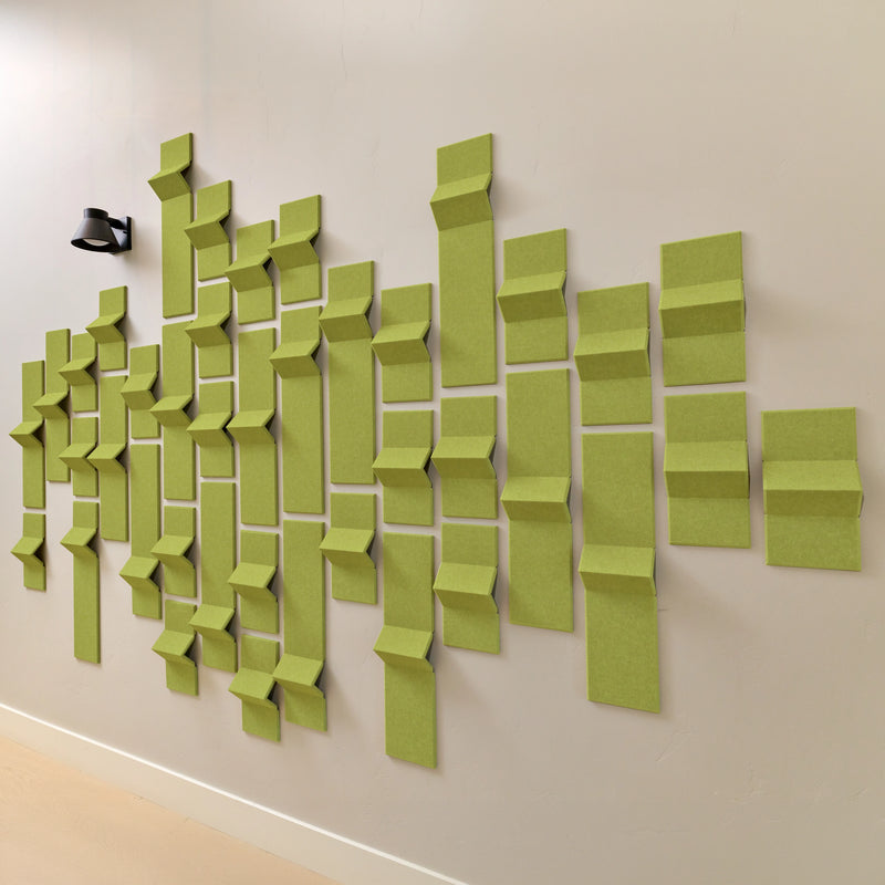 Lime green felt acoustic tiles along a wall in a geometric design 