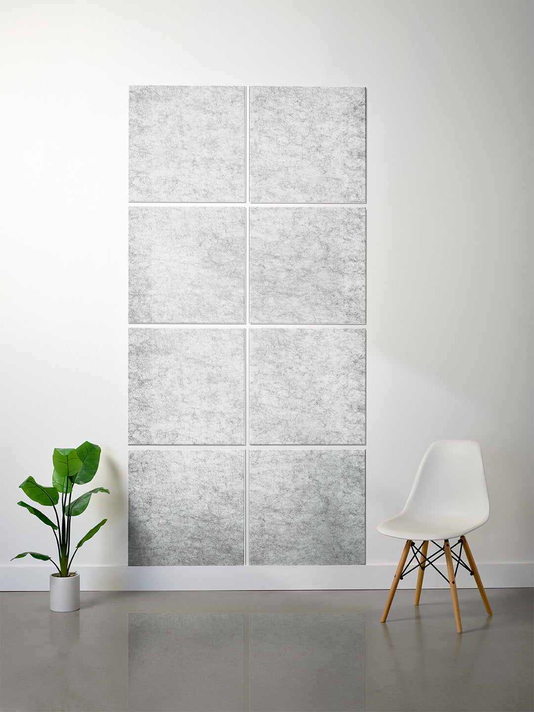 A 6-panel canvas wall art set featuring a light gray and white marble texture, displayed on a white wall in a modern room setting with a white chair and a green potted plant.