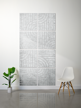 Modern radiator on a white wall with a plant and chair in the foreground