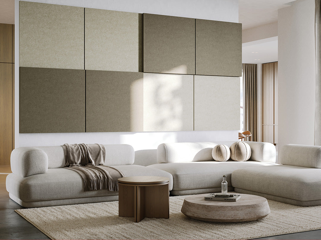 Modern living room with a large sectional sofa, coffee tables, and decorative pillows. Feature Large 3D acoustic boxes from Felt Right in gray and white.