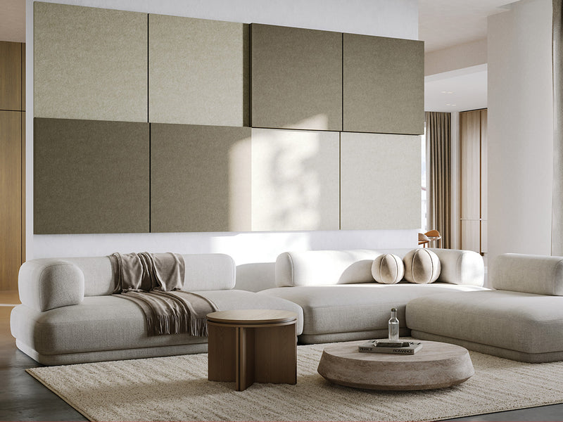 Modern living room with a large sectional sofa, coffee tables, and decorative pillows. Feature Large 3D acoustic boxes from Felt Right in gray and white.