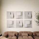 Cream acoustic felt wall tiles arranged in a modern geometric design above a sofa