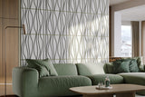 Green sofa in a modern living room with decorative acoustic wall panels and coffee table.