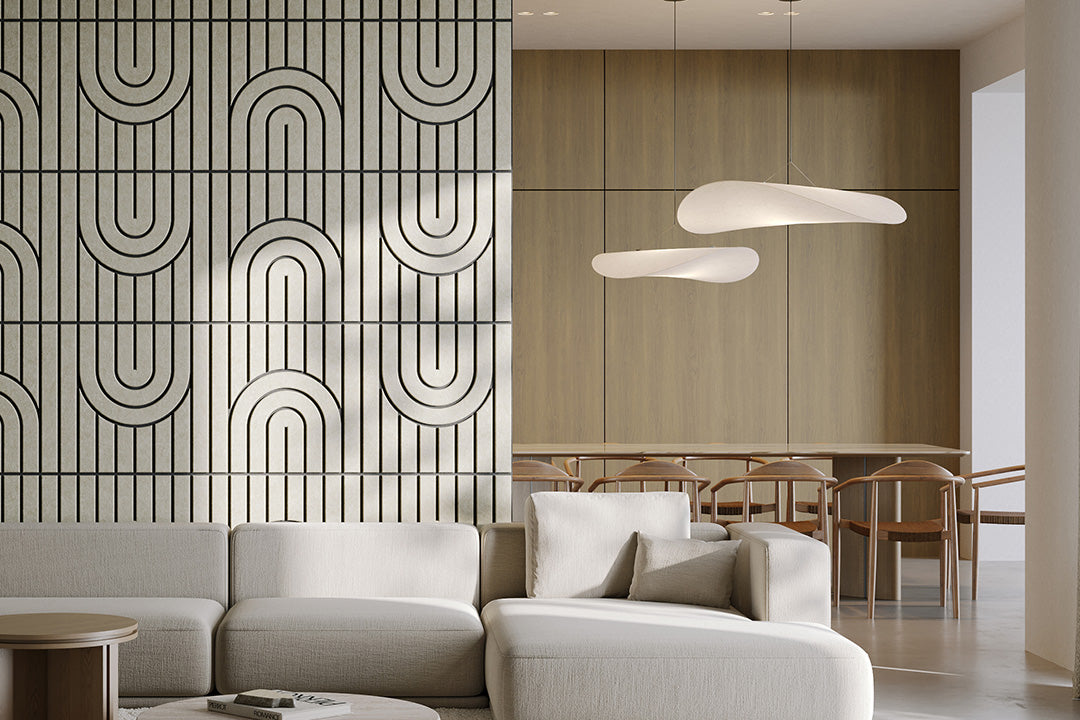 Modern living room with a white sofa, geometric acoustic wall design, and pendant lights.