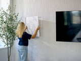Beige textured wall tiles with wavy linear pattern installed in a residential interior.