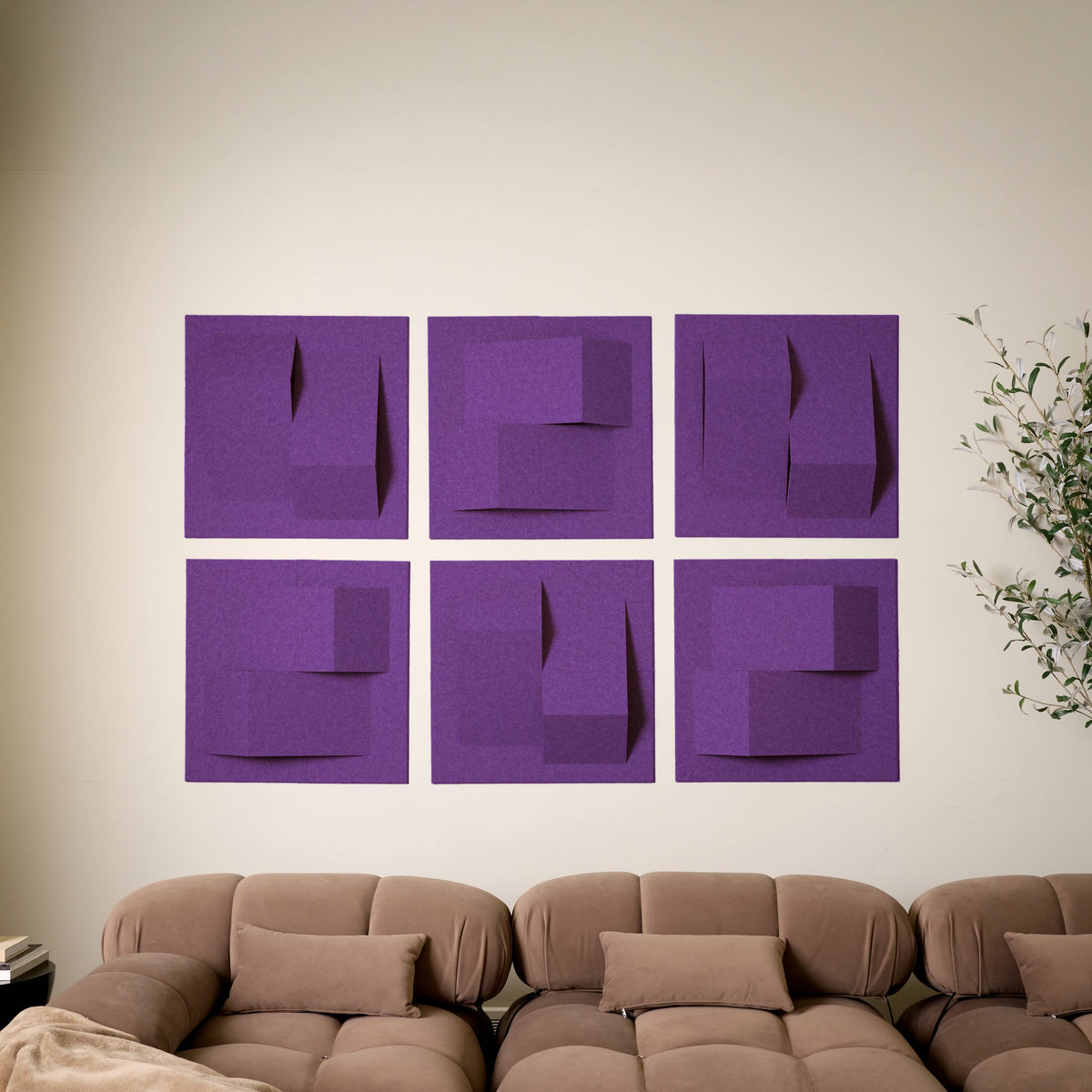 Six purple acoustic felt wall tiles arranged as textured geometric art above a sofa