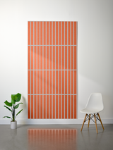 Large orange felt sheet with white engraved parallel vertical lines in a grid pattern.