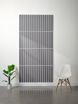Gray felt sheet with engraved parallel vertical lines and horizontal divisions creating a segmented pattern.