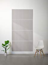 Large rectangular felt sheet with parallel vertical line engravings in four horizontal sections, light gray and white layers 