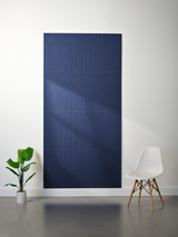 Dark blue felt sheet with parallel vertical engraved lines creating a layered texture pattern.
