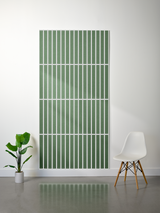 Green felt sheet with engraved parallel vertical lines and horizontal dividing sections, displayed on wall.