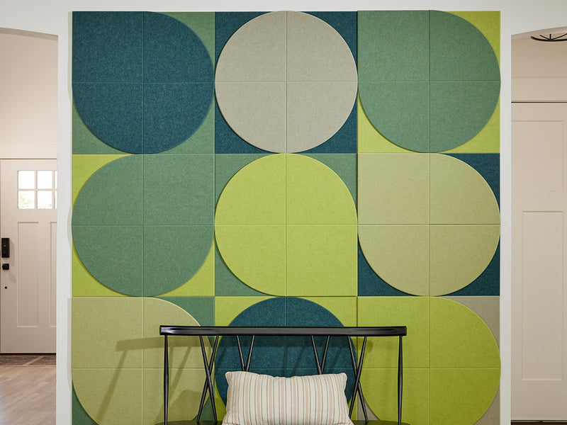 A Felt Right Wall art design using shades of green tiles creating a lily pad look on a wall in a dinning room.