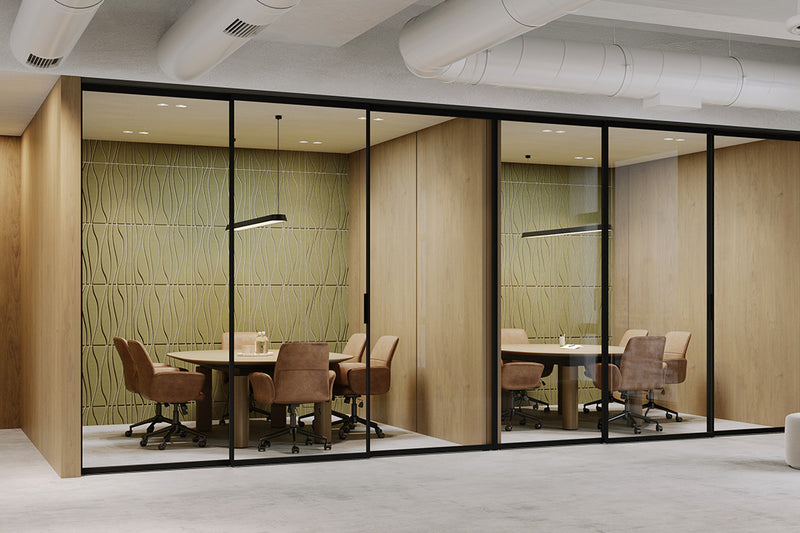 Modern office with glass-walled conference room, olive acoustic panels, and wooden furniture.