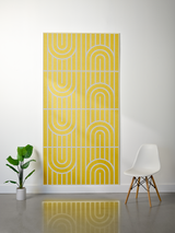Yellow felt sheet with engraved geometric arches and vertical lines arranged in a repeating pattern across four sections.