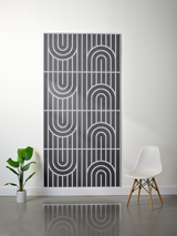 Charcoal felt sheet with layered engraved geometric pattern of vertical lines and arched shapes arranged in four panels.