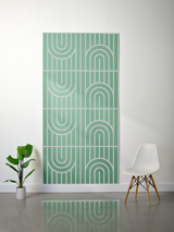 Green felt sheet with layered engraved geometric arch and vertical line patterns in repeating sections.