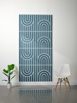 Blue-green felt sheet with white engraved geometric pattern of vertical lines and curved arch designs in four repeating secti