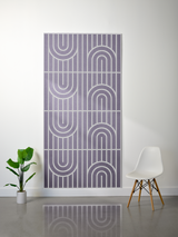 Lavender felt sheet with engraved geometric pattern of vertical lines and nested arch shapes arranged in four horizontal sect
