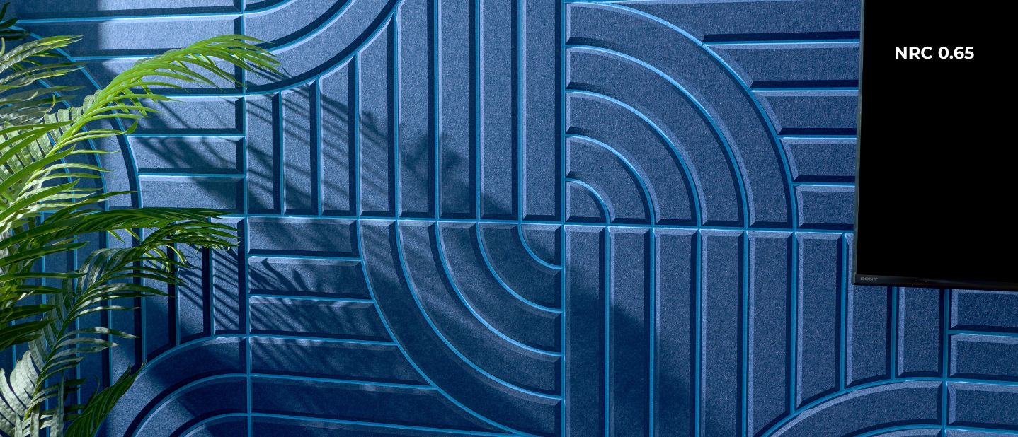 Blue textured wall with geometric patterns and a plant on the left side.