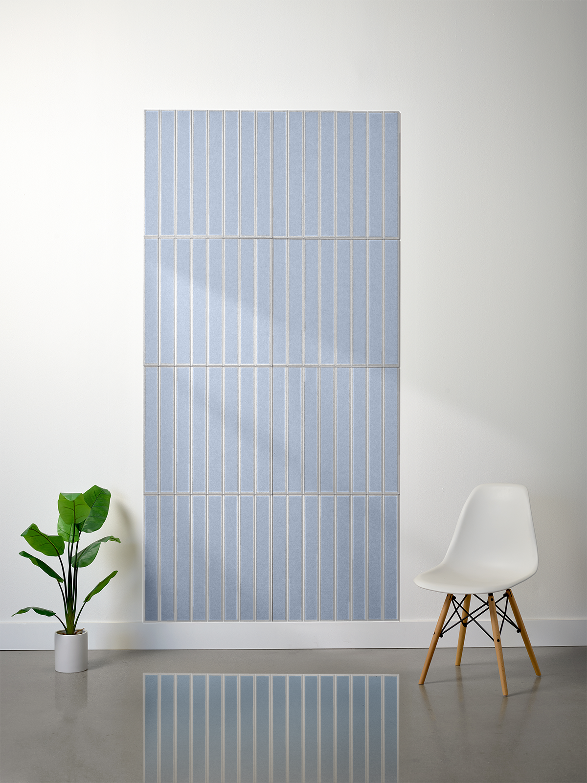 Large blue felt sheet with engraved parallel white vertical lines in multiple sections.