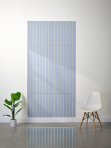 Large blue felt sheet with engraved parallel white vertical lines in multiple sections.