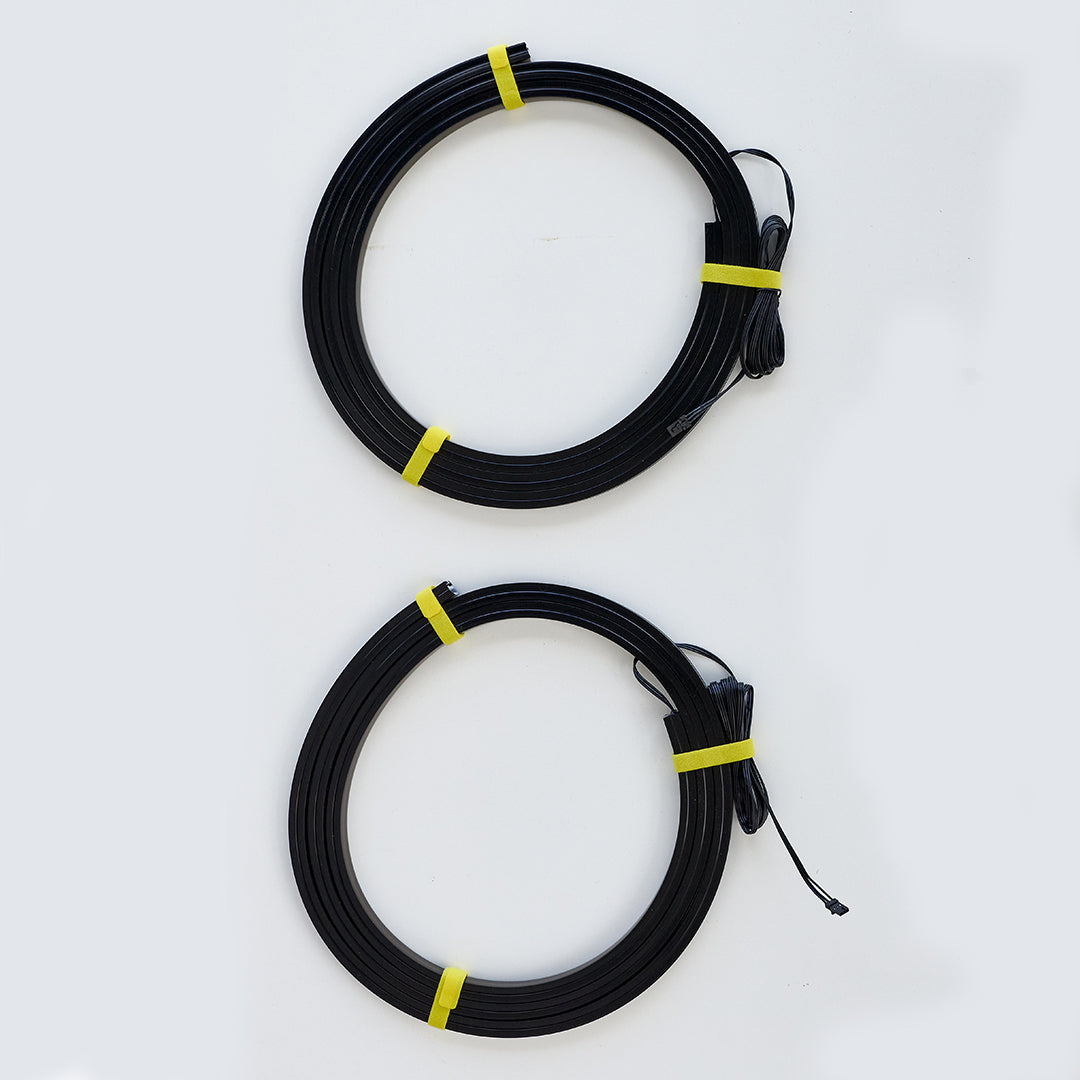 Two coiled black cables, each secured with yellow zip ties, shown on a plain white background.