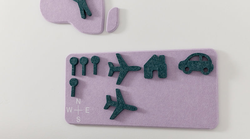 Purple felt board with green felt shapes on a light gray background