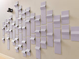 Lavender 3D tiles with angled, dimensional surfaces arranged in an abstract wall pattern.
