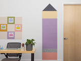 Decorative wall panel shaped like a pencil in an office setting with a desk and door.