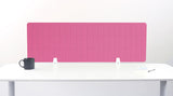 Pink grid desk divider with white mounting brackets on white desk surface.