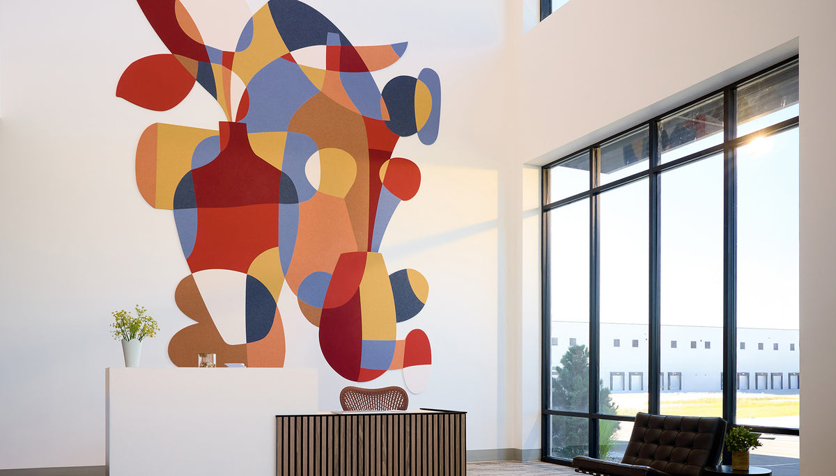 lobby with reception desk and large colorful mural behind it