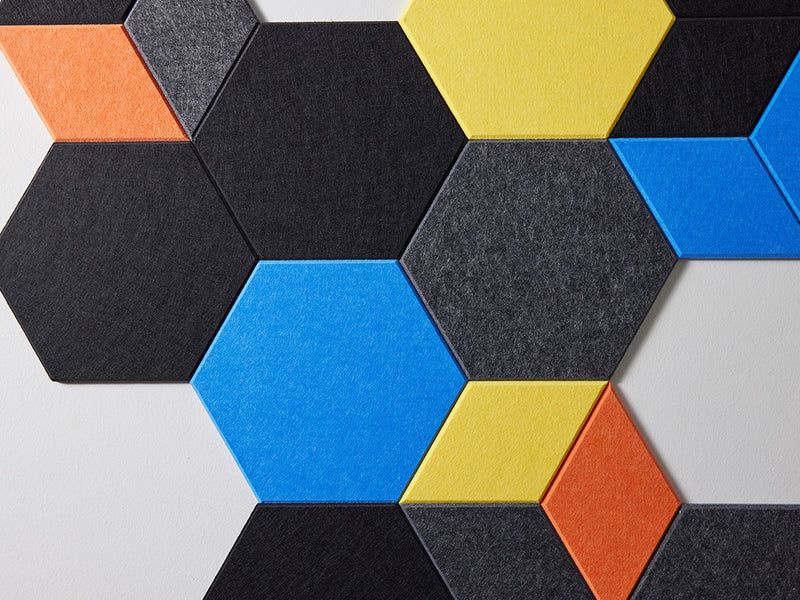 Hexagonal felt tiles in various colors on a white background