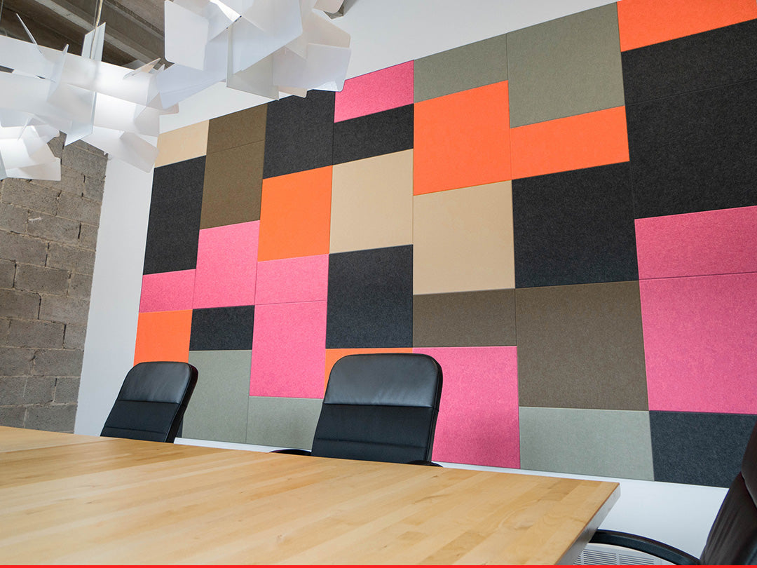Colorful geometric wall panels in a modern office setting with chairs.