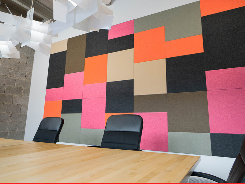 Colorful geometric wall panels in a modern office setting with chairs.