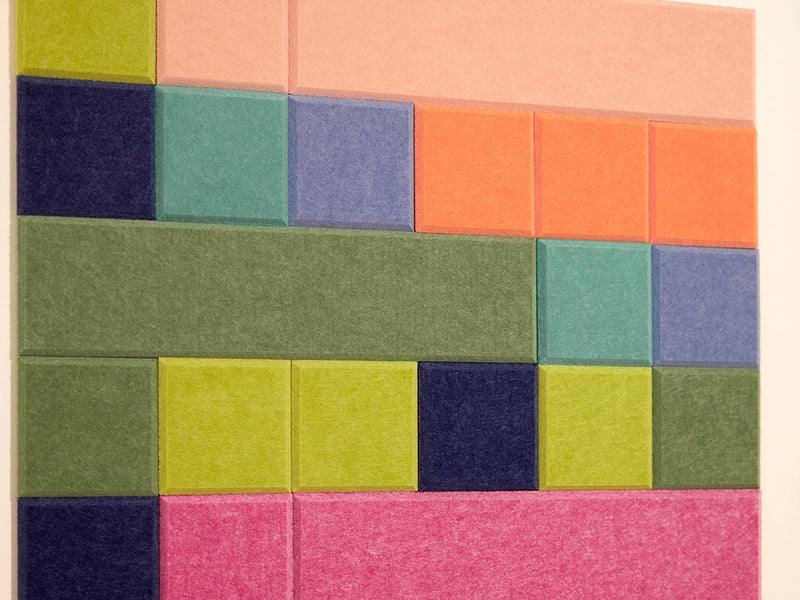Colorful square tiles arranged in a pattern on a beige background