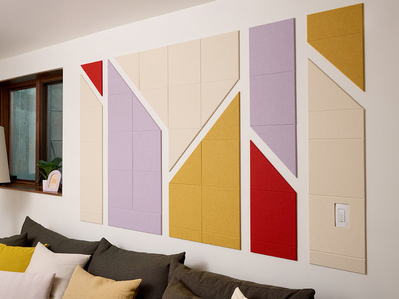 Colorful geometric wall panels in a living room setting.