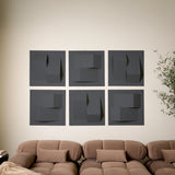 Dark grey acoustic wall tiles with raised geometric shapes used as modern living room decor 