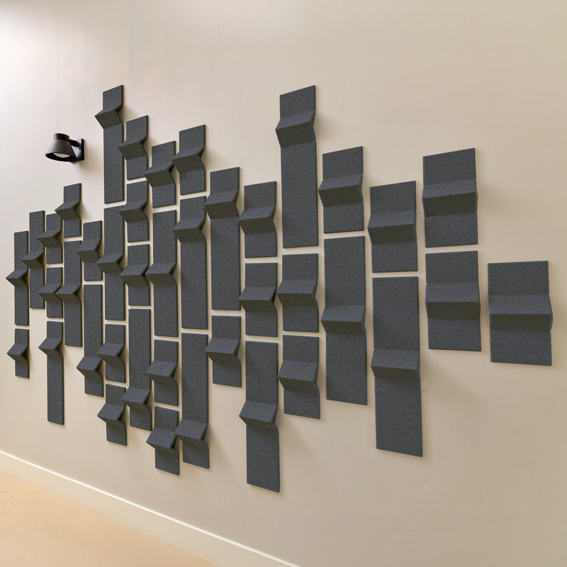 Dark grey acoustic felt tiles with 3D dimension on a wall