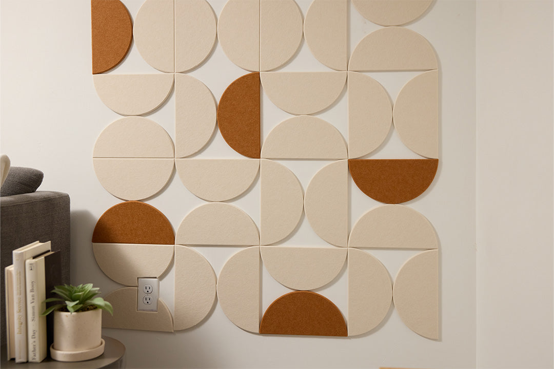 Felt Right wall art design of half circles wall art design with cream and reddish brown accent color next to a couch and side table.