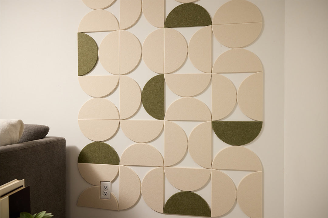 A Felt Right Wall Design using half circles to create wall art design with green and cream accents next to a couch
