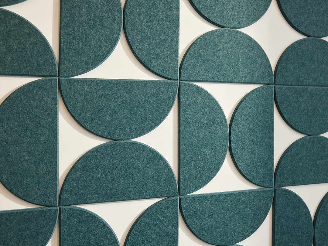 A Felt Right wall art design contemporary geometric-patterned artwork in blue green  hue with negative space on a white wall