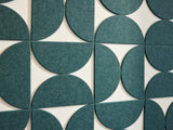 A Felt Right wall art design contemporary geometric-patterned artwork in blue green  hue with negative space on a white wall