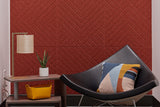 Modern interior with a black chair against a red chevron-patterned acoustic wall.